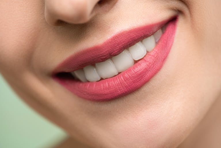 Woman With Red Lipstick Smiling Showing her teeth