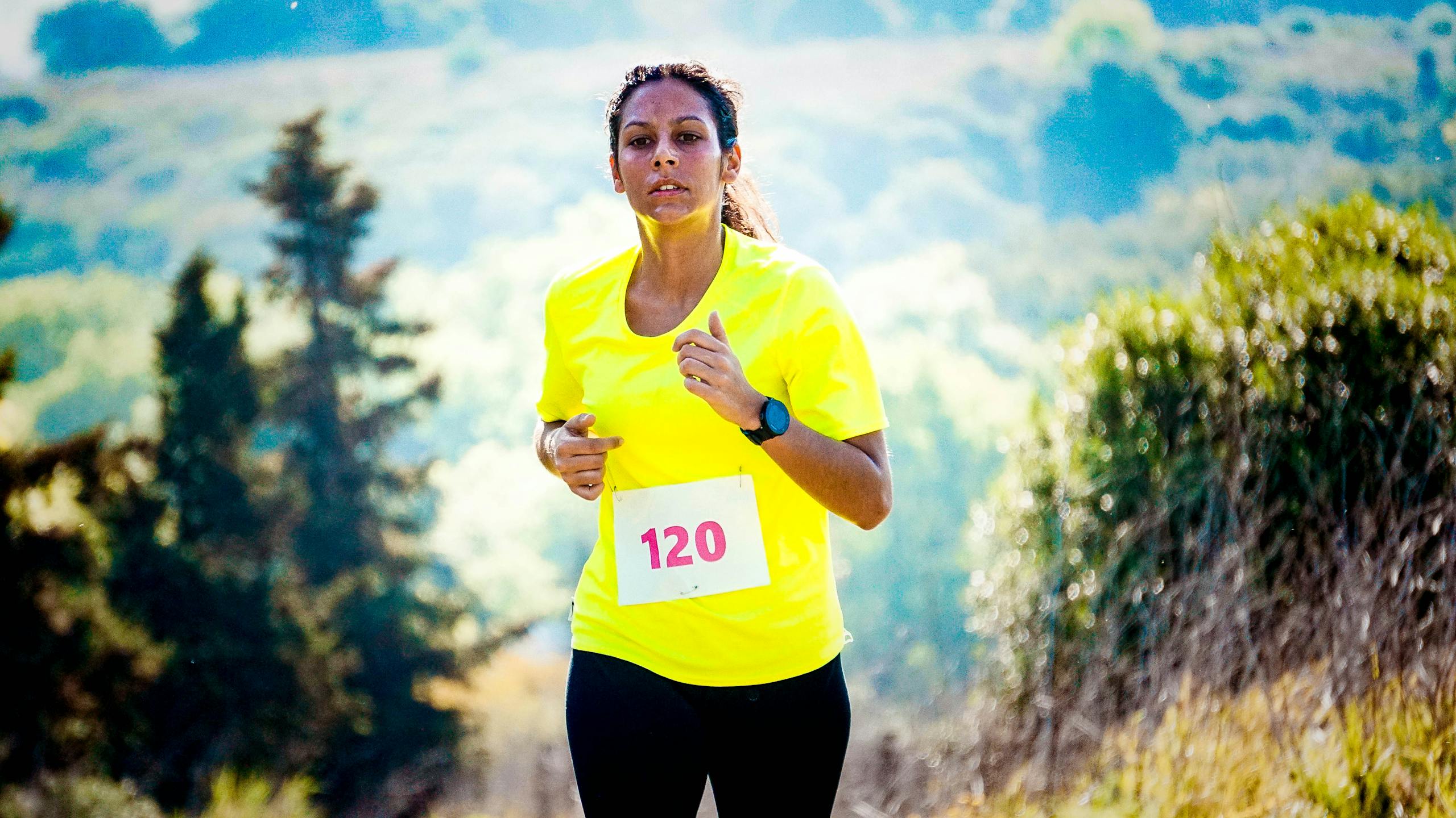 Selective Focus Photo of Woman Wearing Yellow Shirt Running